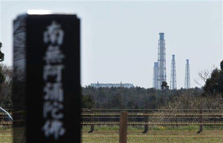 The crippled Fukushima Dai-ichi nuclear power plant overlooks a graveyard and farmland in Futaba, Fukushima Prefecture, northeastern Japan, on April 17. Having survived the March 11 earthquake and tsunami, most of Futaba was intact, but thousands had to evacuate the city in the wake of radiation warnings.